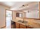 Kitchen sink with granite countertops, and an open doorway leading to the outdoors at 3109 N 81St St, Scottsdale, AZ 85251