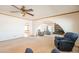 Spacious living room featuring an arched entrance, ceiling fan, and plush carpeting at 3109 N 81St St, Scottsdale, AZ 85251