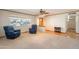 Bright living room featuring a large window, ceiling fan, and a combination of hardwood and carpet flooring at 3109 N 81St St, Scottsdale, AZ 85251