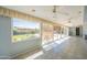 Large sunroom patio with ceiling fans overlooks backyard with pool, grassy area, and fire pit at 3109 N 81St St, Scottsdale, AZ 85251