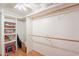 Spacious walk-in closet featuring shelving and multiple wooden rods for optimal storage solutions and organization at 3109 N 81St St, Scottsdale, AZ 85251