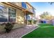 Well kept backyard featuring artificial grass, gravel landscaping, and a covered patio at 3706 E Yeager Dr, Gilbert, AZ 85295