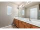 Bathroom featuring a spacious vanity, a large mirror, and a window for natural light at 3706 E Yeager Dr, Gilbert, AZ 85295