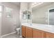 Bathroom with a wide mirror and a wood cabinet under the white sink at 3706 E Yeager Dr, Gilbert, AZ 85295