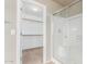 Bathroom featuring a glass door shower and a view into an organized walk-in closet at 3706 E Yeager Dr, Gilbert, AZ 85295