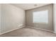 Empty bedroom with neutral carpet and walls featuring a window with blinds at 3706 E Yeager Dr, Gilbert, AZ 85295