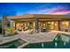 Modern backyard patio with a fireplace, outdoor seating, and a pool and spa at 39810 N 105Th Way # 128, Scottsdale, AZ 85262