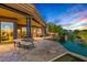 Expansive backyard with a built-in grill, pool, lounge chairs, and covered patio space at 39810 N 105Th Way # 128, Scottsdale, AZ 85262