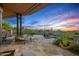 Relaxing backyard patio featuring cozy lounge seating, stunning desert views, and a serene pool at 39810 N 105Th Way # 128, Scottsdale, AZ 85262