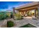 Backyard patio area with outdoor seating, a fireplace, and beautiful desert landscaping at 39810 N 105Th Way # 128, Scottsdale, AZ 85262