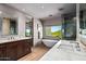 Modern primary bathroom featuring double vanities, a soaking tub, and a separate walk-in shower at 39810 N 105Th Way # 128, Scottsdale, AZ 85262