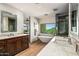Beautiful bathroom featuring dual vanities, a soaking tub with a view, and a modern shower at 39810 N 105Th Way # 128, Scottsdale, AZ 85262