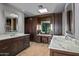 Spacious bathroom boasting dual sinks, vanity area, hardwood floors and beautiful cabinetry at 39810 N 105Th Way # 128, Scottsdale, AZ 85262
