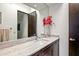 Bathroom featuring granite counters, vessel sink, and decorative red flower arrangement at 39810 N 105Th Way # 128, Scottsdale, AZ 85262