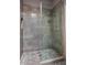Modern bathroom showcasing a glass-enclosed shower with pebble tile flooring, and a tiled shower surround at 39810 N 105Th Way # 128, Scottsdale, AZ 85262