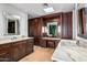 Luxurious bathroom with dual sinks, marble counters, vanity space, and wood cabinets at 39810 N 105Th Way # 128, Scottsdale, AZ 85262