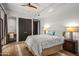 Comfortable bedroom with wood floors, ceiling fan, and large closet at 39810 N 105Th Way # 128, Scottsdale, AZ 85262