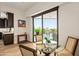 Bright dining area with a glass table and patio access showcasing views of desert landscaping at 39810 N 105Th Way # 128, Scottsdale, AZ 85262