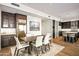 Dining room with a hardwood floor, modern table and chairs, and an open concept view of the kitchen at 39810 N 105Th Way # 128, Scottsdale, AZ 85262