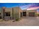 Modern home exterior with a three-car garage, stone accents, and well-maintained landscaping at 39810 N 105Th Way # 128, Scottsdale, AZ 85262