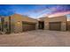 Modern home with three-car garage, desert landscaping, and paved driveway at 39810 N 105Th Way # 128, Scottsdale, AZ 85262