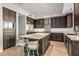 Gourmet kitchen with a large island, marble countertops, stainless steel appliances, and custom cabinetry at 39810 N 105Th Way # 128, Scottsdale, AZ 85262