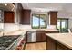 Bright kitchen featuring stainless steel appliances, a view to the exterior, and custom wood cabinetry at 39810 N 105Th Way # 128, Scottsdale, AZ 85262