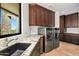 Laundry room featuring front load washer and dryer units and granite countertops at 39810 N 105Th Way # 128, Scottsdale, AZ 85262