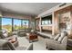 Cozy living room featuring a fireplace, large windows with scenic views, and comfortable seating at 39810 N 105Th Way # 128, Scottsdale, AZ 85262
