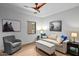 Cozy living area with comfortable seating, ceiling fan, hardwood floors, and natural light at 39810 N 105Th Way # 128, Scottsdale, AZ 85262