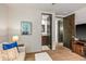 Open living room with wood floors leading to bathroom at 39810 N 105Th Way # 128, Scottsdale, AZ 85262