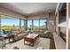 Bright living room with large windows offering views of desert landscape, seamlessly blending indoor and outdoor living at 39810 N 105Th Way # 128, Scottsdale, AZ 85262