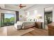 Spacious main bedroom featuring a king bed, tray ceiling, and a picturesque view of the desert landscape at 39810 N 105Th Way # 128, Scottsdale, AZ 85262