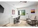 Comfortable home office with desk, chair, accent chair and a window overlooking desert landscape at 39810 N 105Th Way # 128, Scottsdale, AZ 85262