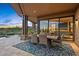 Covered patio features an outdoor dining area with sliding glass doors leading into the home at 39810 N 105Th Way # 128, Scottsdale, AZ 85262