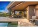 Spacious covered patio features an outdoor dining area, cozy seating, and pool access at 39810 N 105Th Way # 128, Scottsdale, AZ 85262