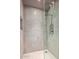 Modern shower featuring neutral tiling, glass enclosure, and minimalist fixtures at 39810 N 105Th Way # 128, Scottsdale, AZ 85262