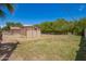 Backyard featuring a shed, a fire pit, and some grass at 4349 W Morten Ave, Glendale, AZ 85301