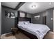 Bedroom boasts dark gray walls, wood beam accent and neutral carpet at 4349 W Morten Ave, Glendale, AZ 85301