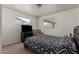 Bright bedroom has neutral carpet, dual windows and a lounge chair at 4349 W Morten Ave, Glendale, AZ 85301