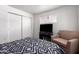 Bright bedroom has neutral carpet, dual windows, a lounge chair and closet at 4349 W Morten Ave, Glendale, AZ 85301