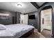 A bedroom boasts a ceiling fan, carpet, and open arch to the bathroom at 4349 W Morten Ave, Glendale, AZ 85301