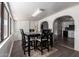 Dining room with an arched entryway to the kitchen and backyard views at 4349 W Morten Ave, Glendale, AZ 85301