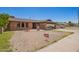 Charming brick home with covered parking and a spacious front yard under a bright sky at 4349 W Morten Ave, Glendale, AZ 85301