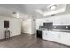 Bright kitchen area shows white cabinets, black appliances and light gray plank flooring at 4349 W Morten Ave, Glendale, AZ 85301