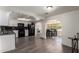Spacious kitchen featuring white cabinets, black appliances, and an adjacent dining area at 4349 W Morten Ave, Glendale, AZ 85301