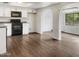 Bright kitchen with white cabinets, dark appliances, and hardwood floors with archways and view at 4349 W Morten Ave, Glendale, AZ 85301