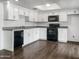 Modern kitchen with white cabinets, dark appliances, and hardwood floors, perfect for any home chef at 4349 W Morten Ave, Glendale, AZ 85301