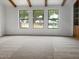 Bright living room with three windows allowing natural light, complemented by a view and neutral walls at 4349 W Morten Ave, Glendale, AZ 85301