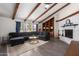 Open living room with vaulted ceilings, wooden beams, and a cozy seating area at 4349 W Morten Ave, Glendale, AZ 85301